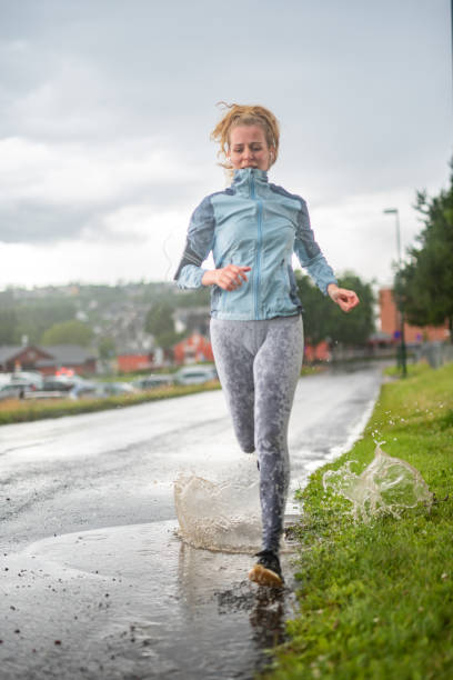 istock Athlete running at the rain. 1263943205