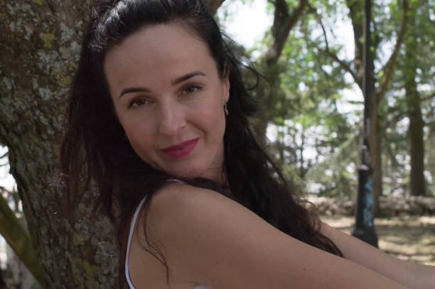 istock Sexy young girl posing leaning on a tree in nature. 1263947063