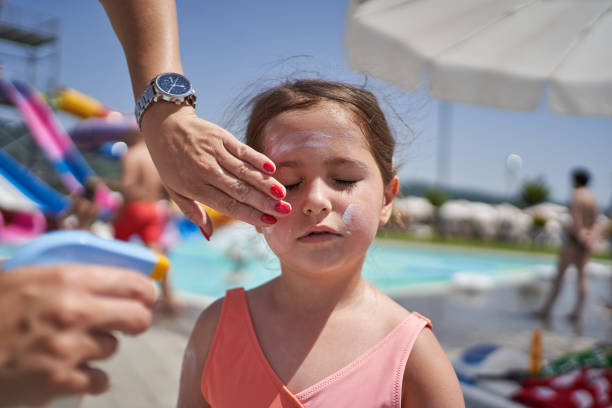 istock Mother applying sunscreen protection lotion on her daughter face 1263948222