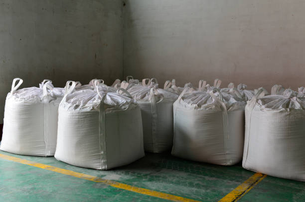 istock Many rows of plastic white sacks with goods are in big warehouse 1263961284