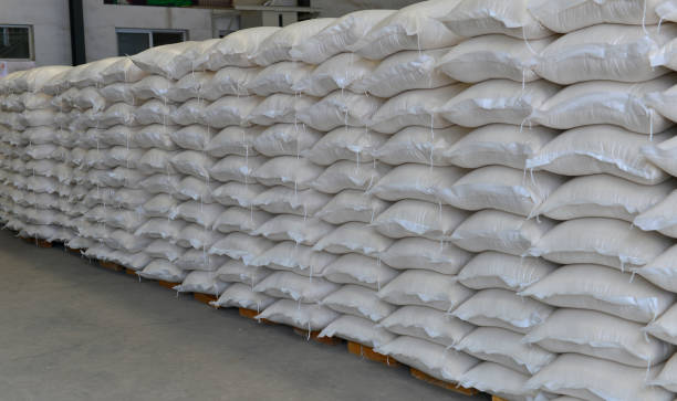 istock Many rows of plastic white sacks with goods are in big warehouse 1263962477