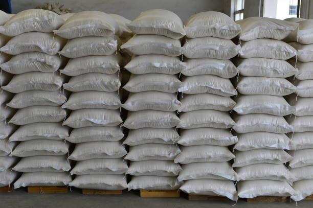 istock Many rows of plastic white sacks with goods are in big warehouse 1263962494