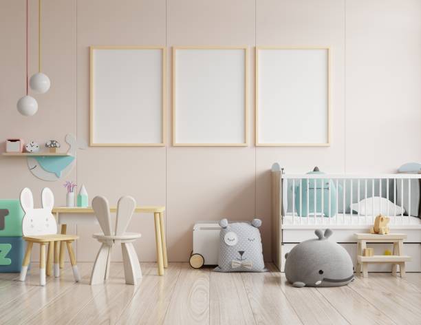istock Mock up posters in child room interior, posters on empty cream color wall background. 1263964272