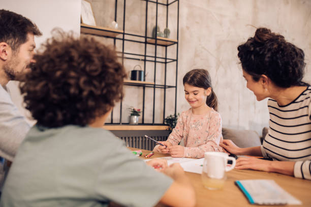 istock Parents spending time with their kids, helping them with homework 1263965489