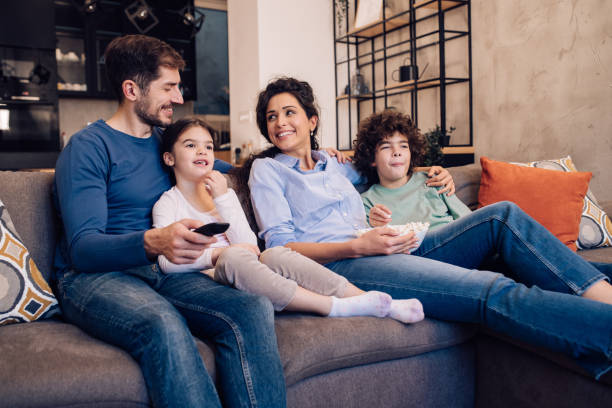 istock Happy family enjoying gathered on the sofa 1263965512