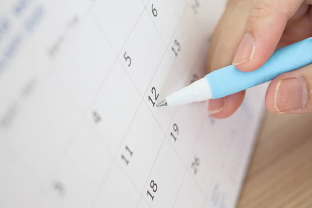 istock Hand with pen writing on calendar date 1263965819