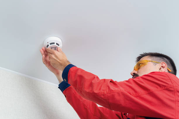 istock Worker installing fire alarm or smoke detector on the ceiling 1263966410