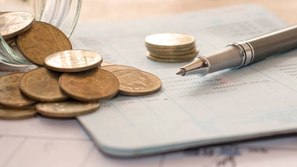 istock The pen is placed on a bill or payroll account with numbers placed on the table, office concept, tax calculation office, financial office and inspection concept. 1263967185