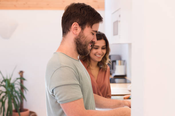 istock Couple cooking together at home 1263972072