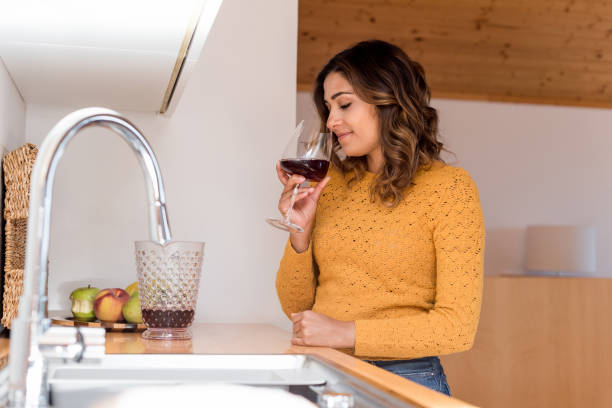 istock Beautiful woman drinking wine 1263972135