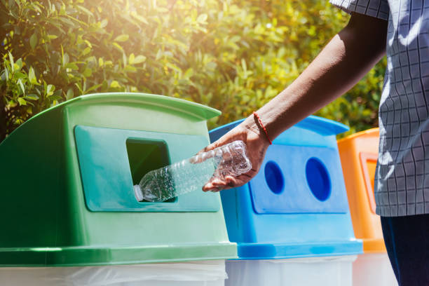 istock black hand throwing an empty plastic water bottle in the recycling garbage trash 1263972190