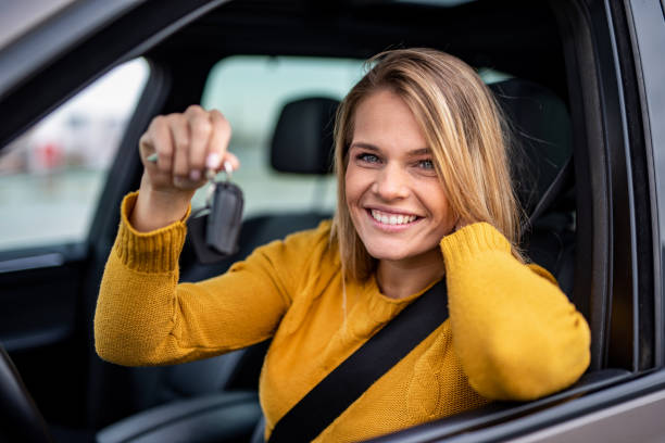 istock Happy young woman bought a new car. 1263973671