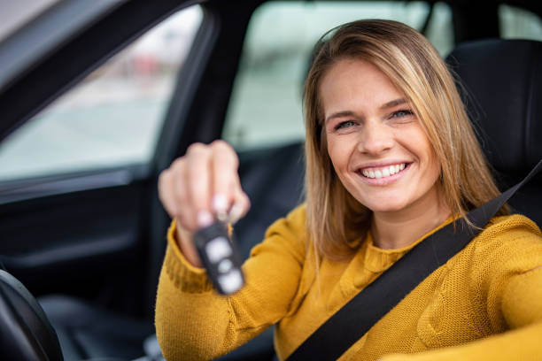 istock Happy young woman bought a new car. 1263973751