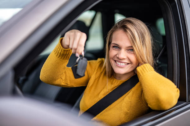 istock Happy young woman bought a new car. 1263973787