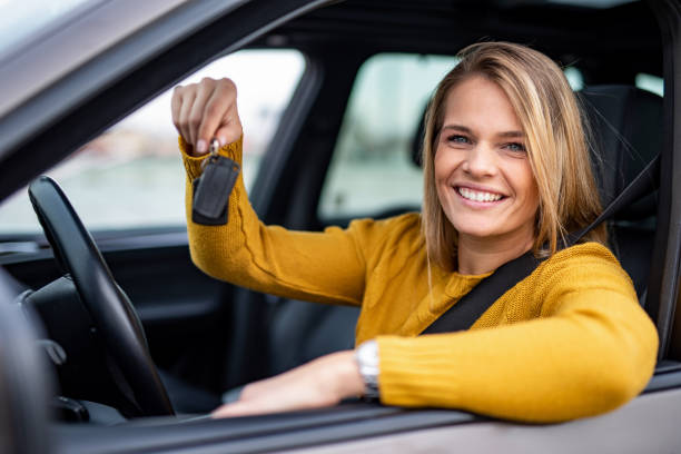 istock Happy young woman bought a new car. 1263973798