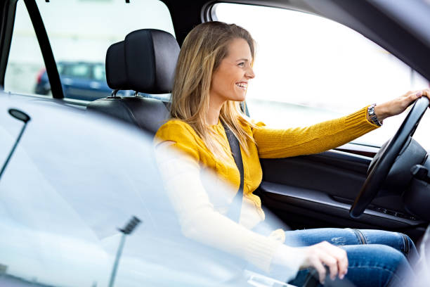 istock Beautiful young woman driving a car. 1263974935