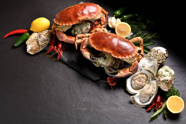 Fresh crabs and seafood arranged on stone background