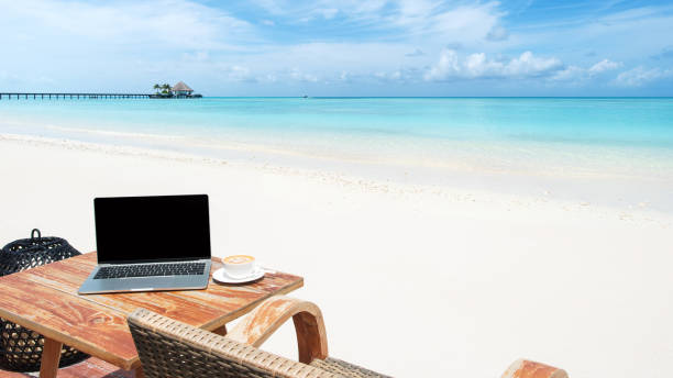 istock Mobile work office on the tropical paradise beach with blank laptop screen 1263976032