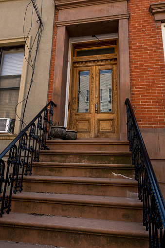 A view of an entrance of a  brownstone