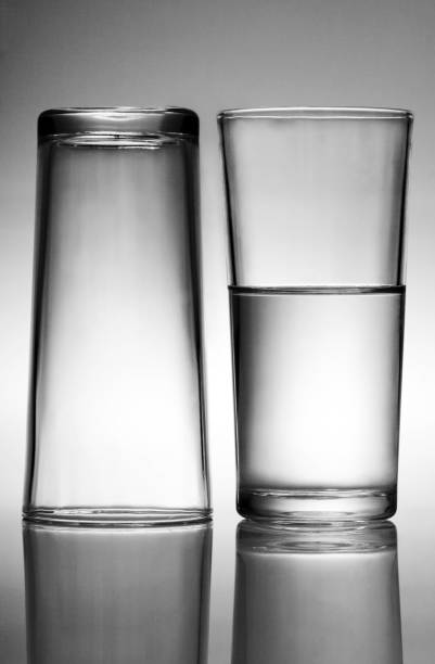 istock A glass of water beside an empty glass 1263980695
