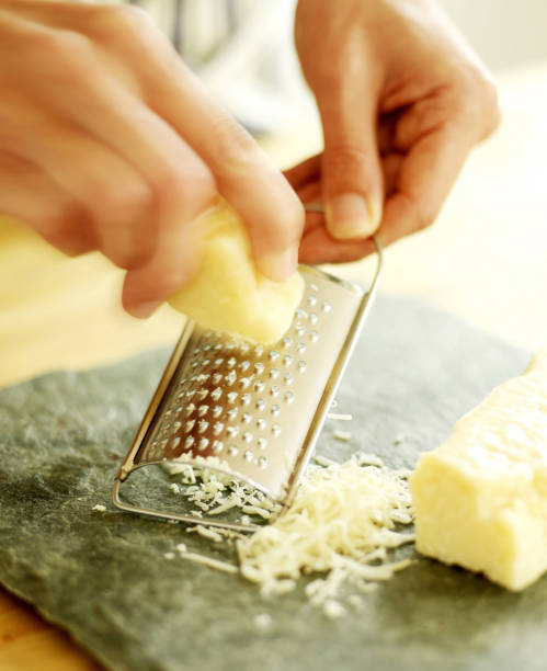 istock Chef grating Parmesan cheese onto a slate surface 1263981856