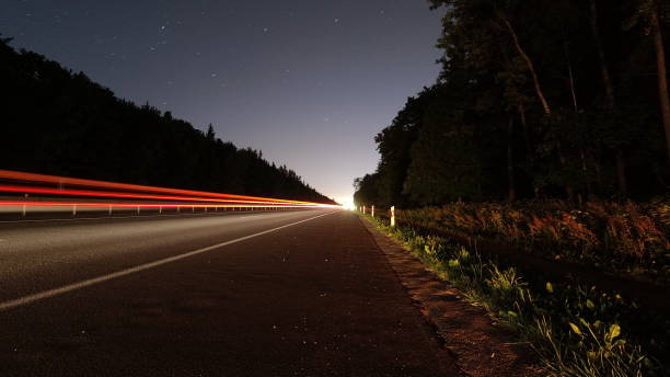 istock Passing cars on a suburban road at long exposure 1263982012
