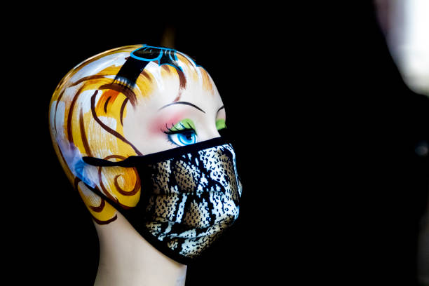 A stylish face mask is displayed on an isolated mannequin head.