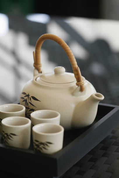 istock Four teacups and pot on tray 1263986323