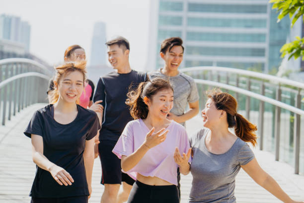istock Group of young asian jogging through city park 1263986556
