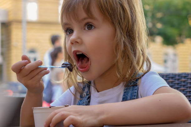 istock little girl eating ice cream 1263989446