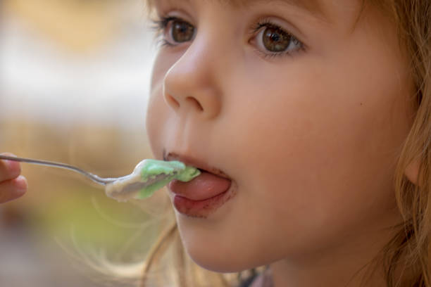istock little girl eating ice cream 1263990487