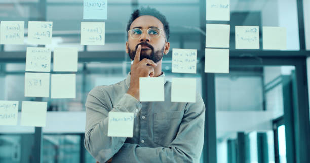 Think ahead to get ahead Shot of a young businessman having a brainstorming session in a modern office mind map photos stock pictures, royalty-free photos & images