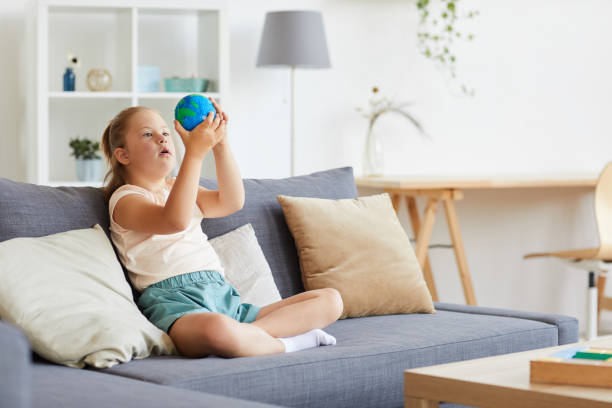 istock Girl examining the planet 1263995445