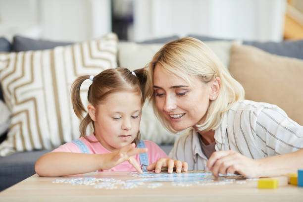 istock Mother and daughter collecting puzzles 1263995622