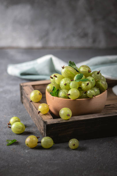 istock Green gooseberry in wooden bowl 1263995721