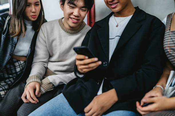 istock Asian teenagers using phone in subway 1263996714