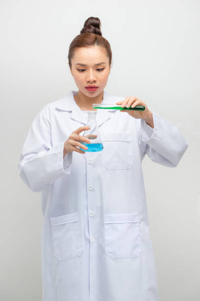 istock Medical student studies reagents. Reagent Mixing in test tubes. 1263996728