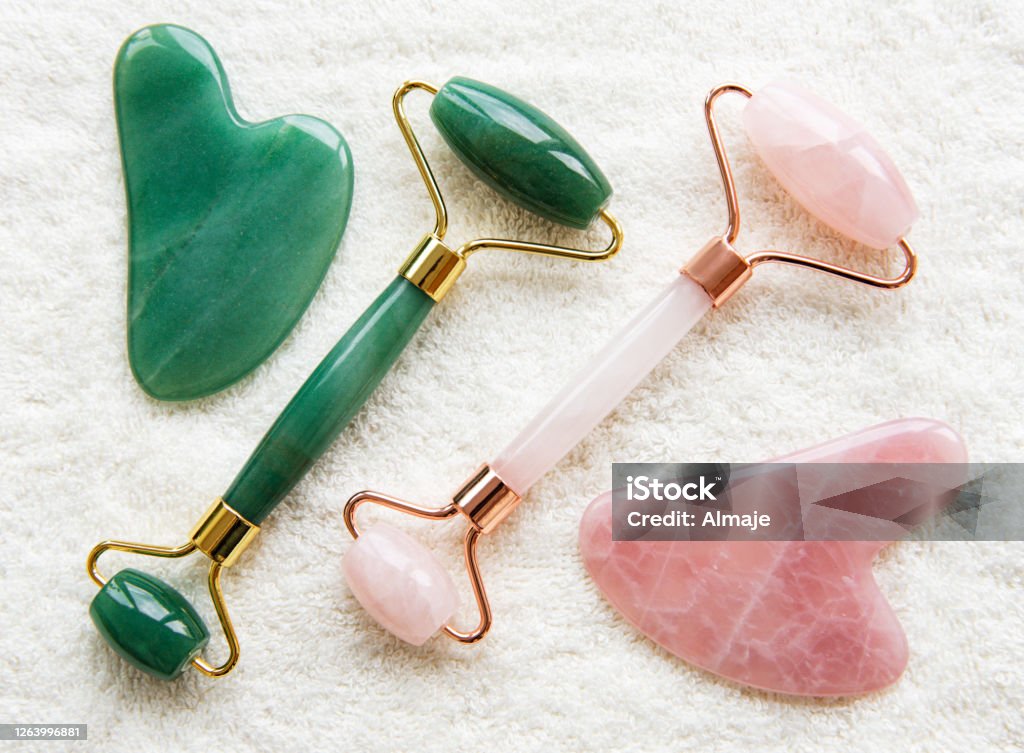 Face jade rollers Jade face rollers for beauty facial massage therapy. Flat lay on wtite towel  background Stone Material Stock Photo