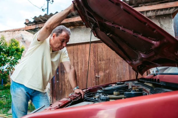 istock Senior man repairing car 1263999847