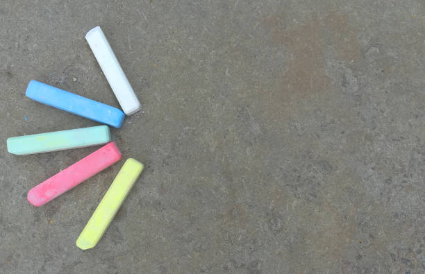 istock multi-colored crayons lie on the asphalt. fun summer game. children drawing, creativity, banner, place for text, copy space 1264000075