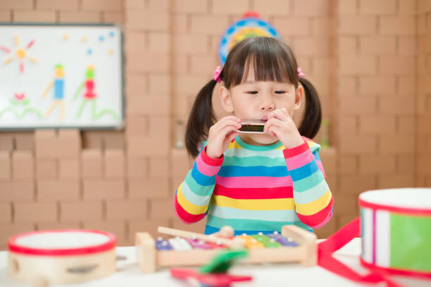 istock young girl plays harmonica at home for home schooling 1264000198