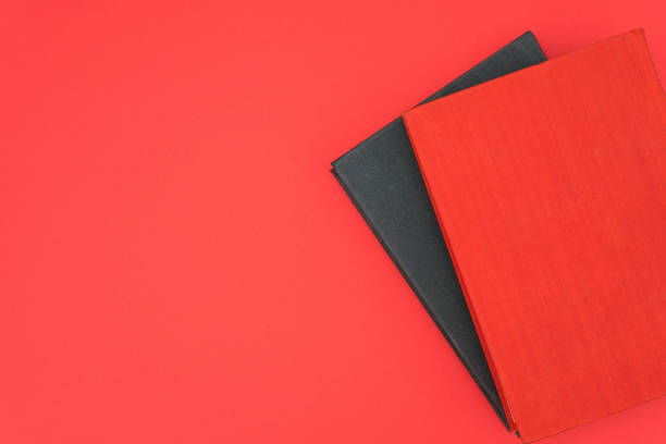 Red and black books on a red background. Copy space. Template
