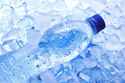 Bottled water with ice cubes