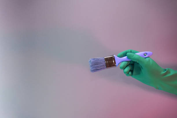 istock Beutiful Hand holding paint brush in the in neon light. Minimalism retro style concept. Background pattern for design. 1264008424