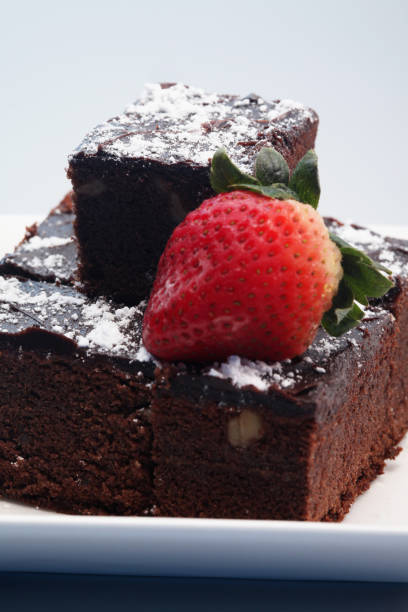 istock Brownies with icing sugar and strawberry 1264008440