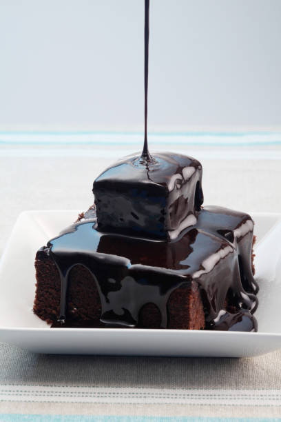istock Pouring chocolate syrup onto brownies 1264008586