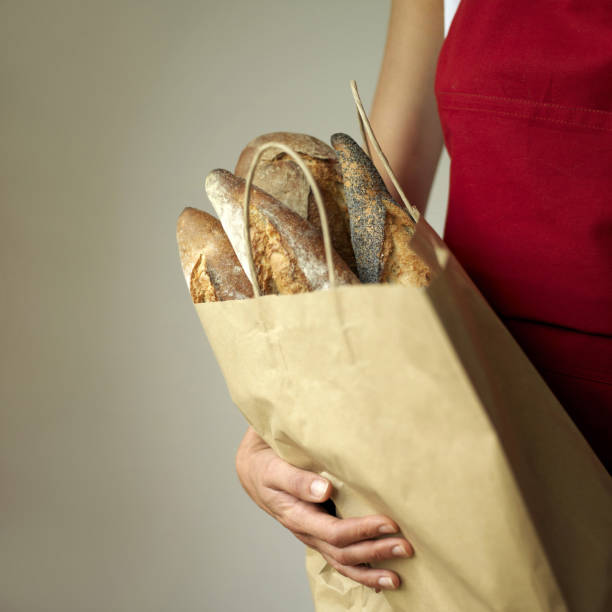 istock A woman holding a bag of breads 1264009584