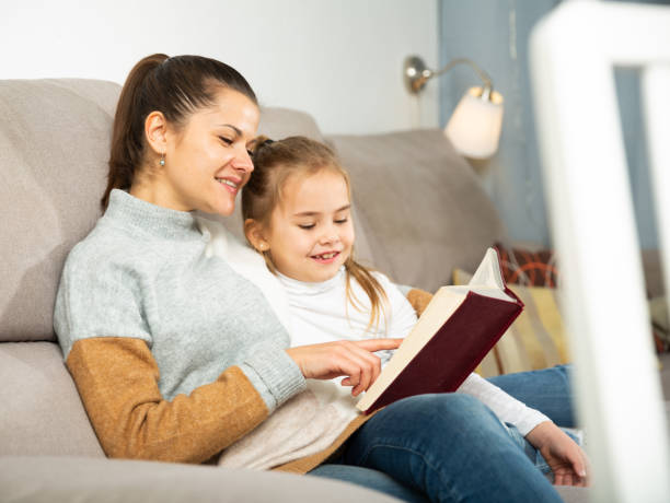 istock Mother reads an interesting book for her small daughter 1264009635