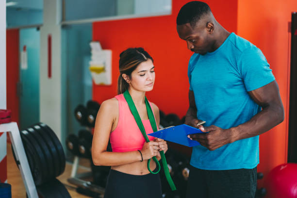 istock Sports training in the gym with personal trainer 1264012216