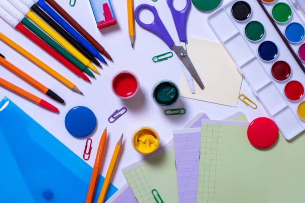 istock Stationery for school are on a white background. Pens, pencils, paints, a folder, notebooks, paper clips, magnets 1264012855